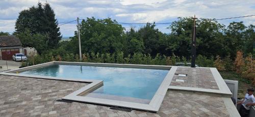 a large swimming pool on a brick patio at Villa One in Jastrebarsko