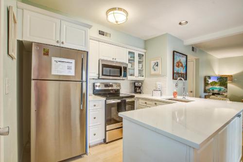 a kitchen with white cabinets and a stainless steel refrigerator at 1641 Courtside in Seabrook Island