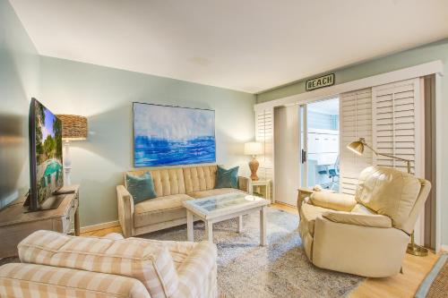 a living room with two couches and a tv at 1641 Courtside in Seabrook Island
