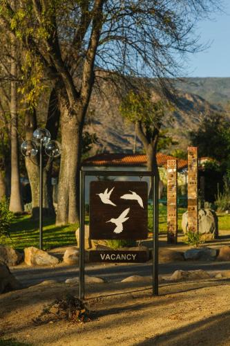 a sign with birds on it in a park at Hummingbird Inn in Ojai