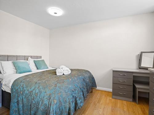 a bedroom with a bed with two towels on it at Gable End Coastal Retreat in Great Yarmouth
