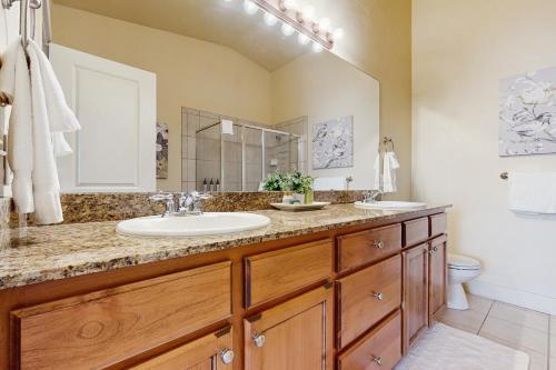 a bathroom with two sinks and a large mirror at Bobsled Haven in Park City