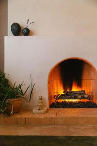 a fireplace in a living room with a fire place at Hummingbird Inn in Ojai