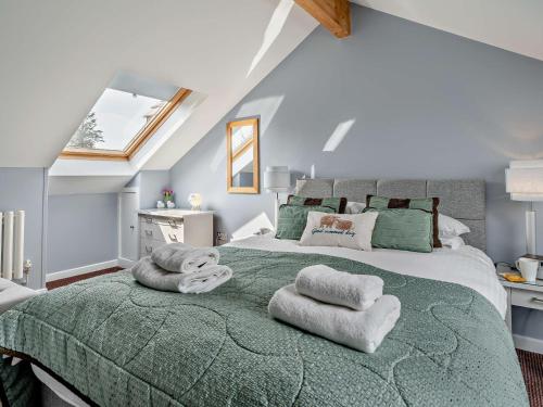 a bedroom with a large bed with towels on it at 1 Bed in Ullswater 90300 in Penruddock