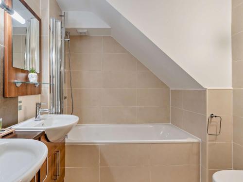 a bathroom with a sink and a bath tub at 1 Bed in Ullswater 90300 in Penruddock