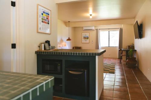 a kitchen with a counter and a stove top oven at Hummingbird Inn in Ojai