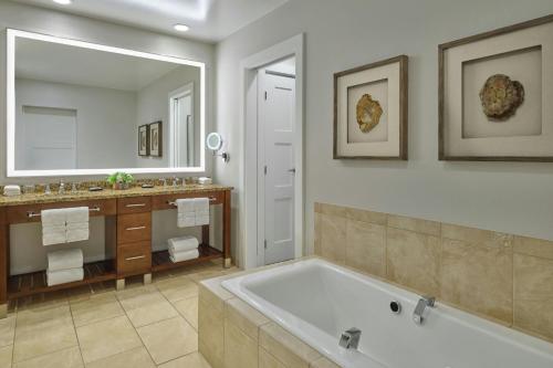 a bathroom with a tub and a large mirror at The Westin Riverfront Mountain Villas, Beaver Creek Mountain in Avon