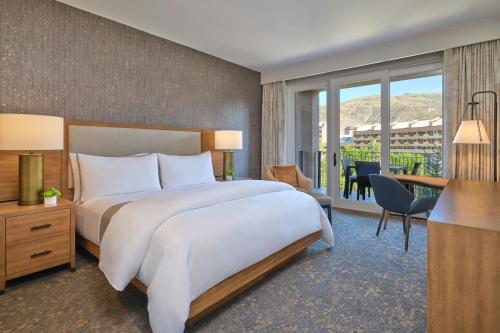 a hotel room with a large bed and a desk at The Westin Riverfront Mountain Villas, Beaver Creek Mountain in Avon