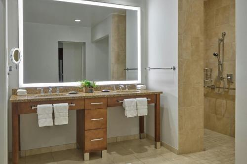a bathroom with a sink and a shower with a mirror at The Westin Riverfront Mountain Villas, Beaver Creek Mountain in Avon