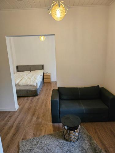a living room with a couch and a bed at Waldeslust Pension in Oelde