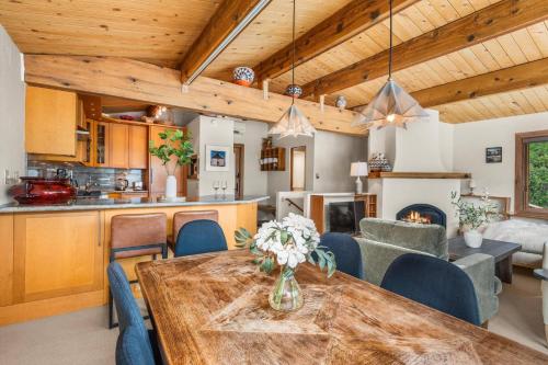 a kitchen and living room with a table and chairs at Shadow Mountain 10 in Aspen