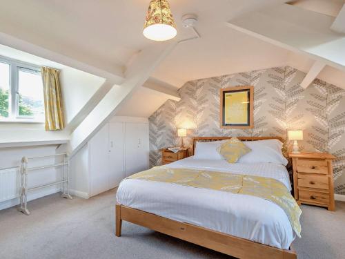 a bedroom with a king sized bed in a attic at 3 Bed in Chapel Stile SZ161 in Chapel Stile