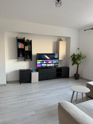a living room with a large flat screen tv at Millo Apartament in Bucharest