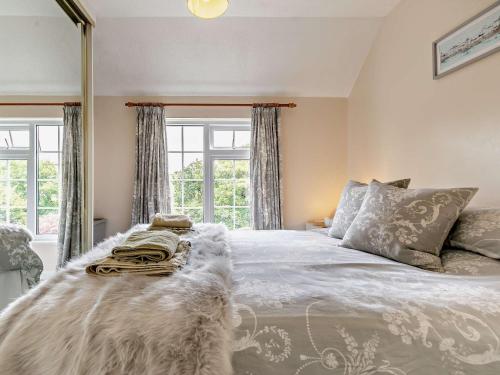 a bedroom with a large bed and a window at 1 Bed in Perranporth COLMA in Perranporth