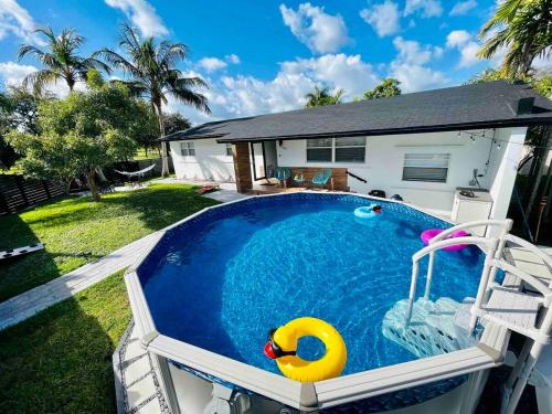 a swimming pool with a yellow float in a yard at Villa Las Olas Designed with you in mind! in Fort Lauderdale