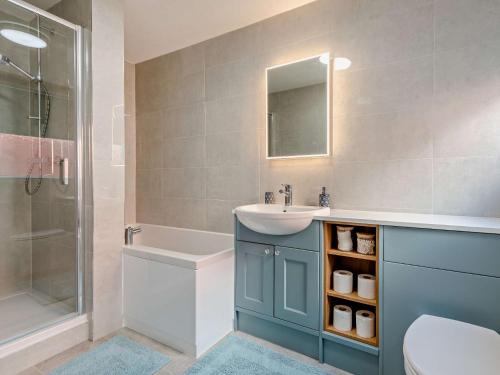 a bathroom with a sink and a toilet and a shower at 2 Bed in Swanage 90116 in Swanage