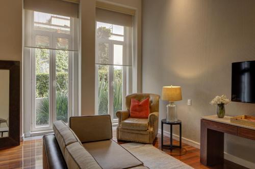 a living room with a couch and a chair at Hacienda Peña Pobre in Mexico City