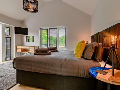 a bedroom with a large bed and a desk at 4 Bed in Weybourne 91228 in Weybourne