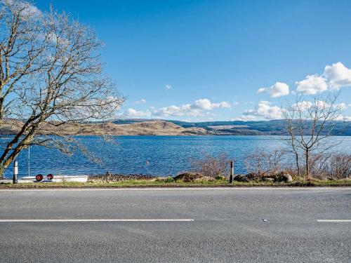a road next to a large body of water at 1 Bed in Inveraray 91310 in Crarae
