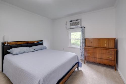 a bedroom with a bed and a dresser and a window at Dock Access Waterfront Studio in Colonial Beach! in Colonial Beach