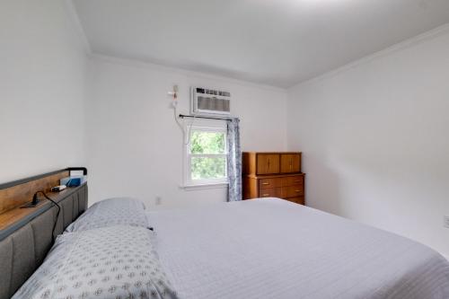 a white bedroom with a bed and a window at Dock Access Waterfront Studio in Colonial Beach! in Colonial Beach