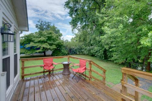 two chairs and a table on a wooden deck at Dock Access Waterfront Studio in Colonial Beach! in Colonial Beach
