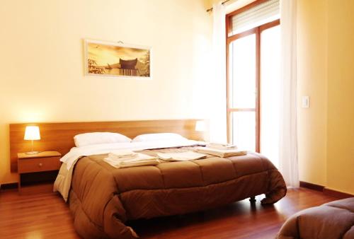a bedroom with a bed and a large window at Central Plaza in Lecce