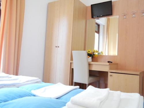 a bedroom with two beds and a desk and a mirror at Central Plaza in Lecce