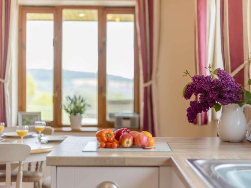 a plate of fruit on a counter in a kitchen at 3 bed in Worcester CC037 in Clifton upon Teme