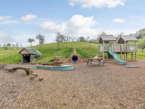 a park with a playground with a slide and a slideintend at 3 bed in Worcester CC037 in Clifton upon Teme