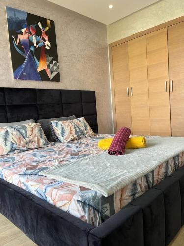 a large bed in a bedroom with a large bedvisor at M&S House prestigia plage des nations in Sale