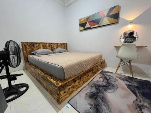 a bedroom with a bed and a desk and a camera at D' Mande Homestay Bukittinggi in Bukittinggi