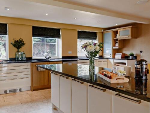 a kitchen with a center island with a vase of flowers at 6 Bed in Ellington 91805 in Ellington