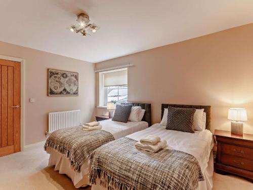 a bedroom with two beds and a window at 6 Bed in Ellington 91805 in Ellington