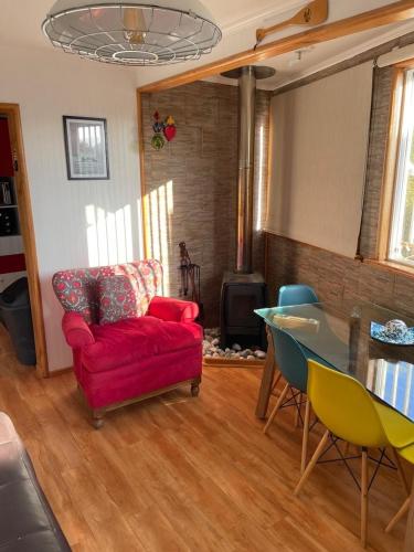 a living room with a red couch and a table at Amazing Rooftop Views and Free Parking in Mirasol in Mirasol