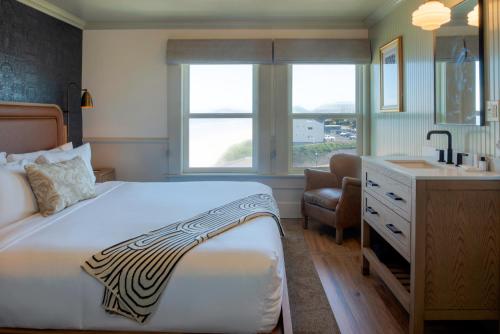 a bedroom with a bed and a desk and a window at Hotel Sylvia in Newport
