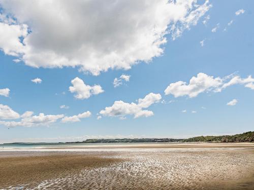 a beach with a blue sky and clouds at 2 Bed in Stepaside 91799 in Stepaside