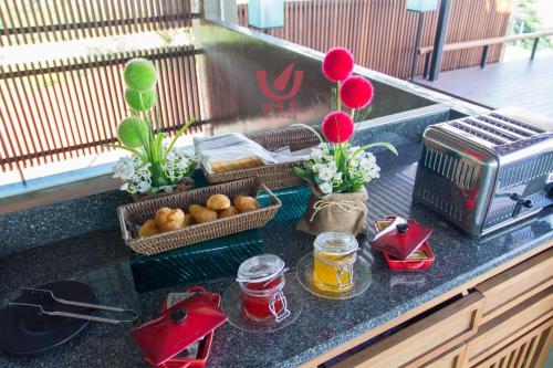 a kitchen counter with fruit and flowers and a toaster at Kroque Boutique & Bistro in Ang Sila