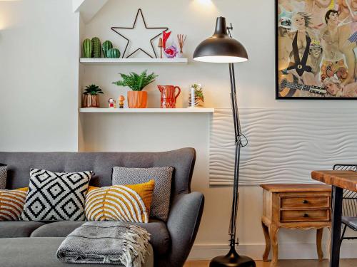 a living room with a gray couch and a lamp at 2 Bed in Lizard 45739 in Ruan Major