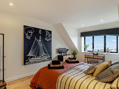 a bedroom with a large bed and a painting on the wall at 2 Bed in Lizard 45739 in Ruan Major