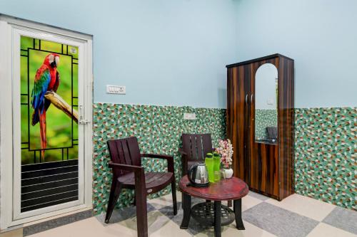 a dining room with a parrot painting on the wall at OYO Flagship Hotel O Mo Kudia in Puri