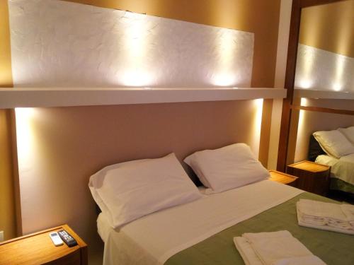 a hotel room with a bed and a mirror at Mirage Lecce in Lecce