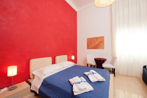 a bedroom with a blue bed with towels on it at Mirage Lecce in Lecce