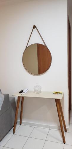 a mirror on top of a table next to a couch at Ap no Turu, 10 min das praias in São Luís