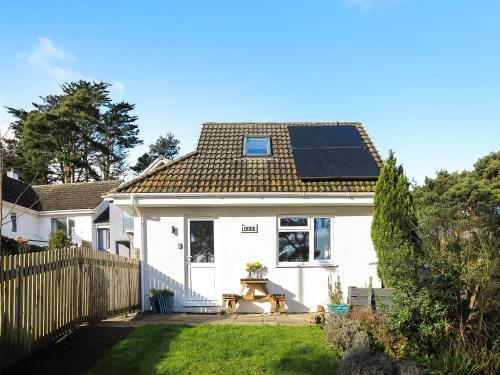 a house with a solar panel on the roof at The Lodge in Carlyon Bay