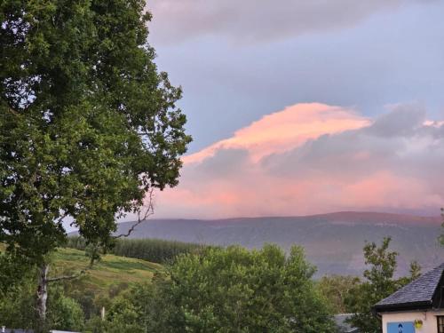 a cloud in the sky over the mountains at Tonita, River Black Water Holiday Lets, INCHBAE, GARVE, IV232PG in Garve