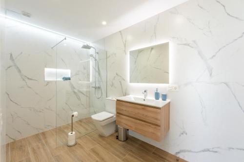 a bathroom with a toilet and a sink and a shower at Saras Village in Adeje