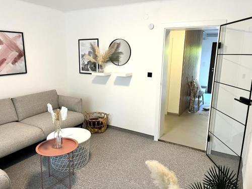 a living room with a couch and a table and a mirror at Haus Enn in Neukirchen am Großvenediger