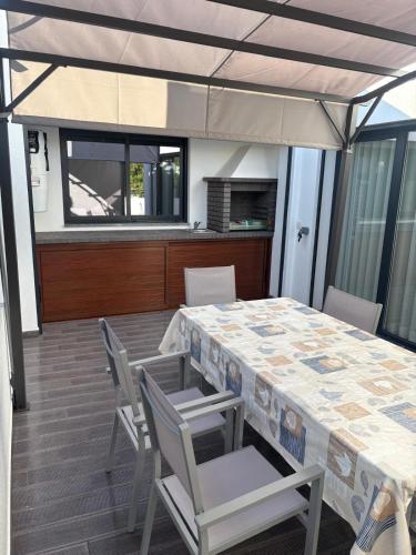 a dining room with a table and chairs at Aroeira Beach Home in Almada