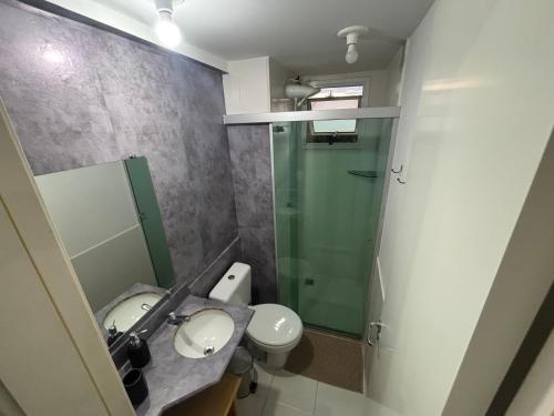 a bathroom with a shower and a toilet and a sink at park style aconchego in Brasilia